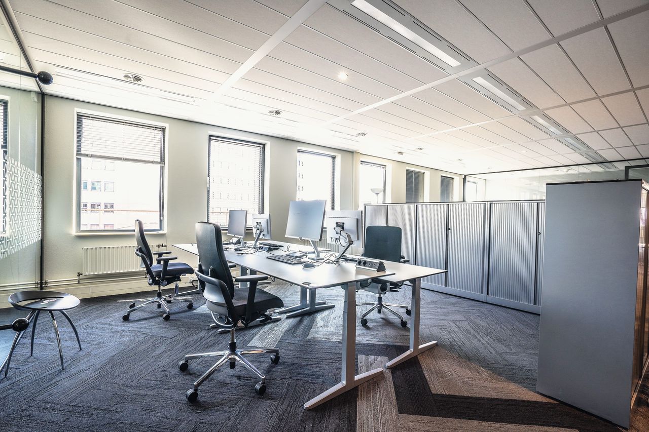 An open office on a weekday morning, the desks still empty